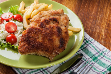 Cutlet Cordon Bleu with pork loin served with French fries and salad