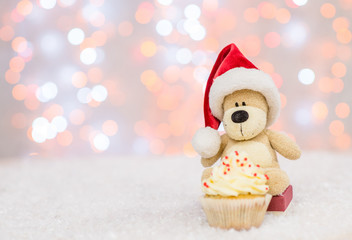 Toy bear in red santa hat with cupkace. Christmas holidays background with copy space for your text