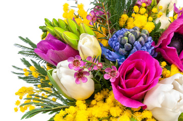 Elite spring bouquet with mimosa and other flowers, close up on a white background
