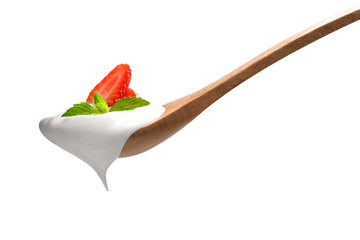 Plain yogurt on a spoon with fresh strawberry on top isolated on white background