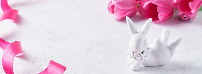 Easter background with pink tulips and cute bunny.