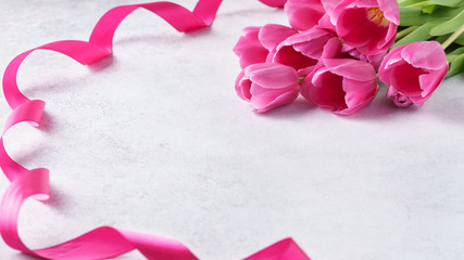 Valentines Day background with pink tulips and ribbon.