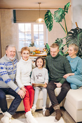 smiling gorgeous family sitting on the couch with a laptop. internet. communication.family...