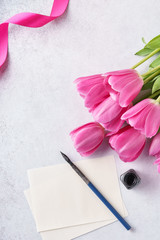 Valentine's Day greeting card with list of paper, tulips and pen