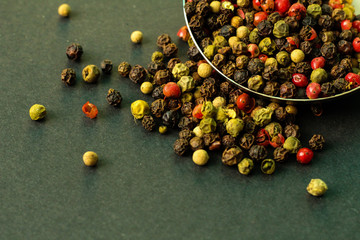 Colorful peppercorns, dark background, free copy space