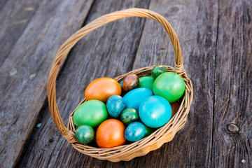 Colorful Easter egg in the nest on wooden background