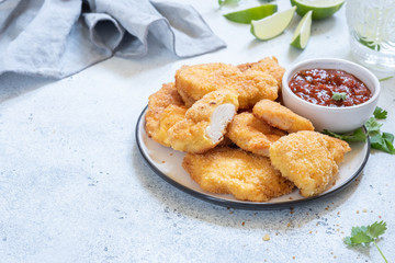 Fried crispy chicken breast nuggets with sauce