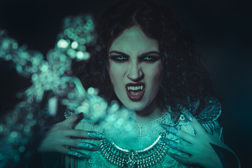 fear of the cross vampire, demonic woman dressed in white lace and silver jewelry. has fangs and...