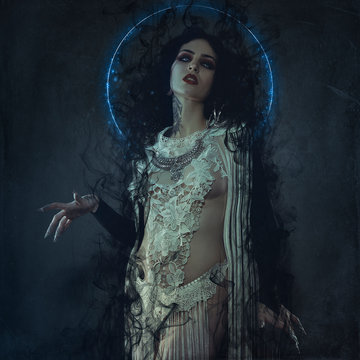 vampire, demonic woman dressed in white lace and silver jewelry. has fangs and thick brown hair
