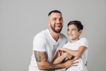 positive laughing daddy and son enjoy time. close up photo. happiness, warm relationship. happy childhood. feeling, emotion . parenthood