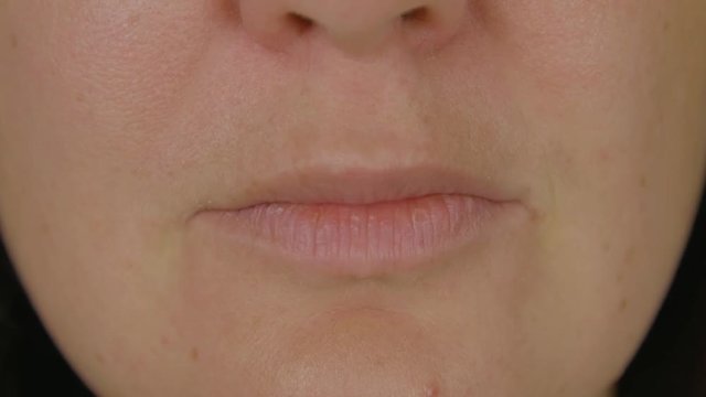 Woman with natural rose lips close up. Front view macro smile and throw kiss