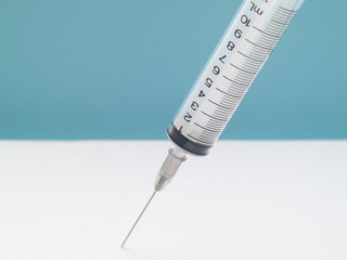 syringe on blue background