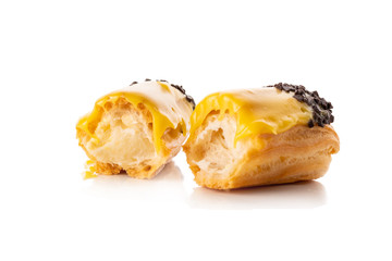 Eclair with yellow cream isolate on white background
