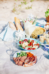 Tasty food and accessories outdoor summer or spring picnic. Lunch in the beach.