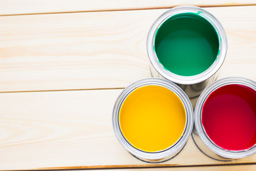 House renovation concept, colorfull paint cans on wooden background