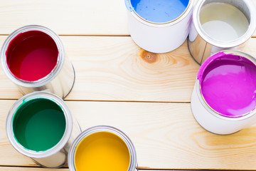 House renovation concept, colorfull paint cans on wooden background
