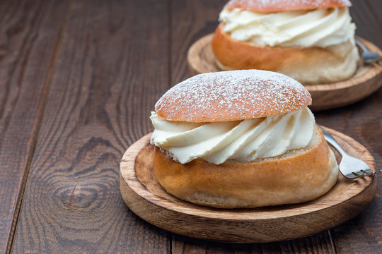 Traditional swedish dessert Semla or Shrove bun, with almond paste and whipped cream filling, horizontal, copy space