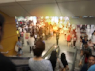 blurred image of Crowded station with people and passenger standing, walking and waiting for pick and choose the best public transport during rush hour in Bangkok city.