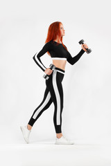 Sporty fit woman, athlete runner makes fitness exercising with dumbbells on white background.