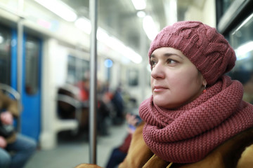 Woman standing in subway train