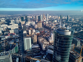 Fototapeta na wymiar WARSAW, POLAND - NOVEMBER 27, 2018: Beautiful panoramic aerial drone view to the center of Warsaw City and The Warsaw Spire - 220 metre neomodern office building on European square (Plac Europejski)