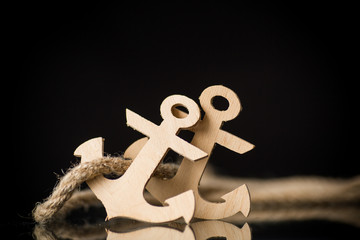 wooden decorative anchor on a black background
