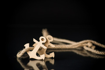 wooden decorative anchor on a black background