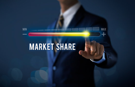 Market growth, increase market share or business growth concept. Businessman is pulling up progress bar with the word MARKET SHARE on dark tone background.