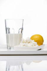 Dairy products, milk and sour-milk cottage cheese, cheese on a white background with a place for the text.