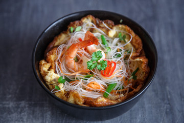 Asian salad with rice noodles with shrimps and vegetables closeup.