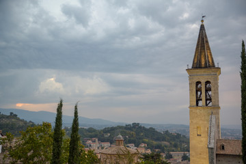 Fototapeta na wymiar Italian village. Bell tower of the Cathedral of Spoleto, Santa Maria Assunta.