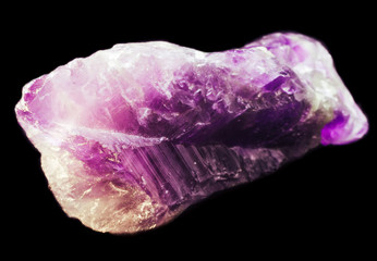 Small natural amethyst crystal on black background