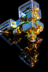 Synthetic iridescent stone bismuth macro on black background