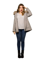 A full-length shot of a Teenager girl with coat has just realized something and has intending the solution on isolated white background