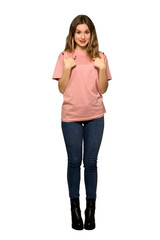 A full-length shot of a Teenager girl with pink sweater with tired expression on isolated white background