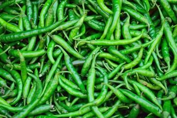 Macro details of Fresh Green Chilies at street side vegetable market in India 