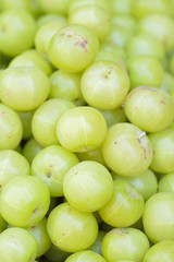 Fresh Indian gooseberry fruits at street side vegetable market in India 