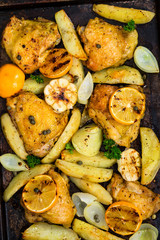 Roasted Chicken with Potatoes and Meyer Lemon. Selective focus.