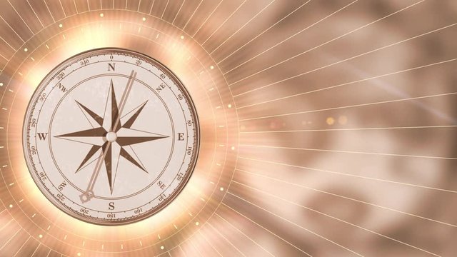 Vintage gold compass on blurred motion background. Retro stale
