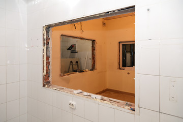 Repair and replacement windows in office building, destroyed window partitions of bricks, tiles. Concept construction team, finishing works, redecoration, cabinet reconstruction, wall dismantling