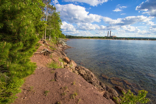Marquette Michigan. Beautiful city park on the shores of Lake Superior with industrial plant in the background.  