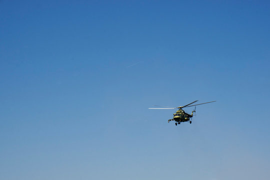 Combat helicopter in blue sky