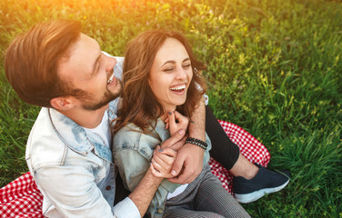 Laughing couple hugging on grass