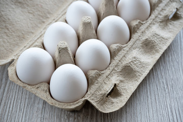 Chicken eggs on wooden table.