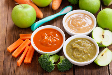 Baby food. Various bowls of fruit and vegetable puree, top view