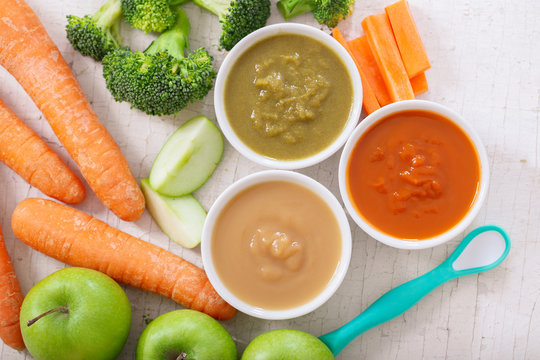 Baby food. Various bowls of fruit and vegetable puree, top view