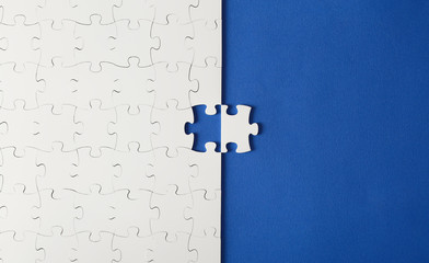 White puzzles on a blue background with one missing piece