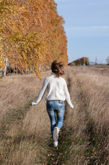 Naklejka na ściany i meble young woman walking in the countryside