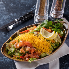 Tasty  salad with salted salmon and fresh vegetables. Closeup