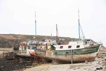 old rusted fishing boats abandoned on the land at the atlantic ocean